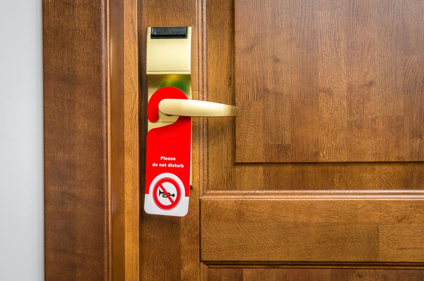 Entrance door of hotel room with sign please do not disturb Zimmertür mit do not disturb Schild