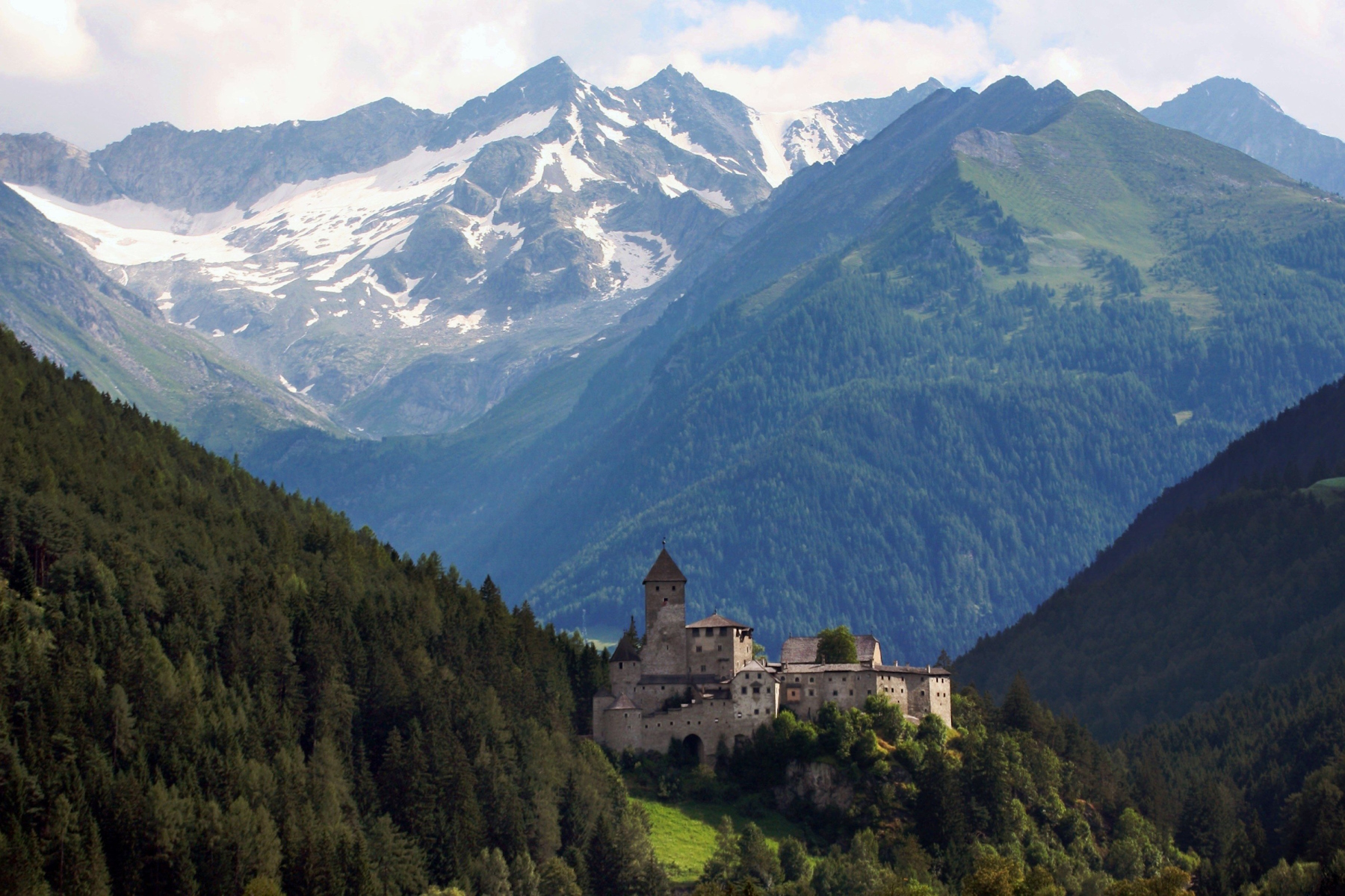 Medieval castle of Taufers with beautiful Dolomites mountains in the background The medieval castle of Taufers with beautiful Dolomites mountains in the background